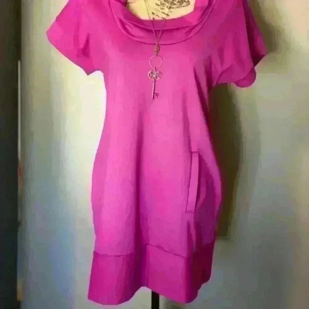Pink knee length top with pockets.